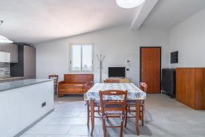 a kitchen and dining room with a table and chairs at Villa Caterina in Solarino