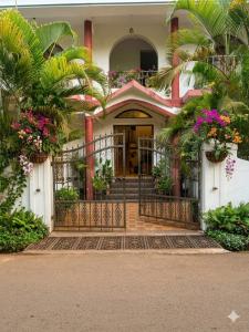 an entrance to a building with a gate and flowers at Daffodil in Anjuna