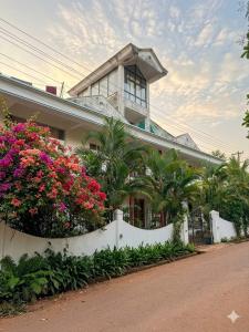 a house with flowers in front of it at Daffodil in Anjuna