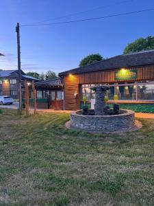 a building with a fountain in the middle of a yard at Travel Plaza Hotel in Desborough