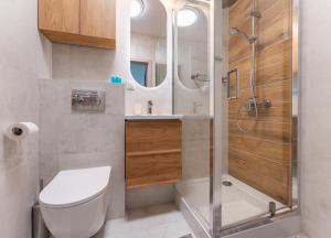 a bathroom with a toilet and a shower at Rumia Stylish Apartment by BookingHost in Rumia +15 photos