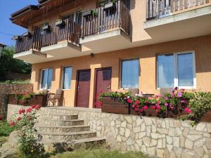 a house with flower boxes and a stone wall at Miranis in Byala