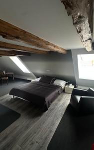 a bedroom with a large bed and a couch at Chez Gilles Hôtel Restaurant SA in La Chaux-de-Fonds