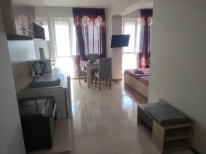 a hotel room with a bed and a kitchen and a bathroom at Miranis in Byala