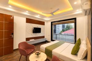 a hotel room with a bed and a large window at Mazestic Bay Hotel & Banquet in Noida +78 photos