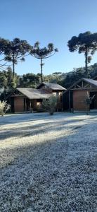 a house with trees in the background at Chalés sítio anjo gabriel 3 in Urubici +12 photos