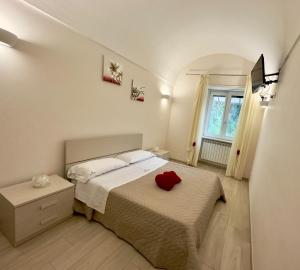a bedroom with a bed with a red heart on it at Blu costiera Casa Vacanze in Maiori