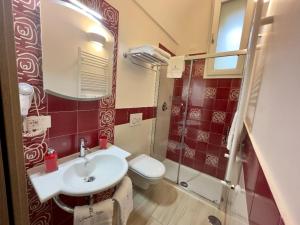 a bathroom with a white sink and a toilet at Blu costiera Casa Vacanze in Maiori +1 photo