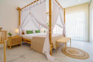 a bedroom with a canopy bed in a room at Paradise Villa Sea - Signature by Paradise Portugal in Ribamar