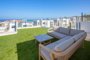 a couch and a table on the roof of a house at Paradise Villa Sea - Signature by Paradise Portugal in Ribamar