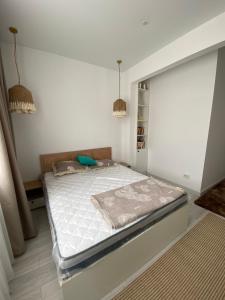 a bedroom with a large bed in a room at SF Residence in Bosteri