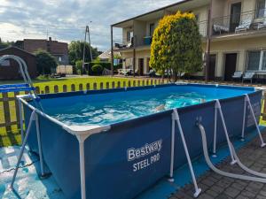 a large plunge pool in a yard with a house at Pokoje i Domki Nadmorskie - Bajkowa Mierzeja in Stegna