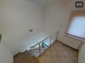 a staircase in a white room with a window at Apartments Tutto Bene in Jajce +2 photos