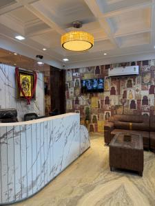 a lobby with a couch and a table in a room at SR Palace - Best Hotel in Vrindavan Near Prem Mandir and Iskcon Temple with Private Parking in Vrindāvan