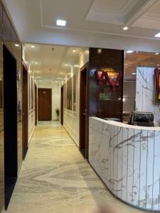 a corridor in a hotel with a lobby with a marble counter at SR Palace - Best Hotel in Vrindavan Near Prem Mandir and Iskcon Temple with Private Parking in Vrindāvan