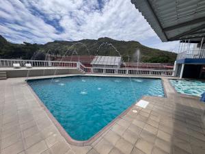 a large swimming pool with water fountains on a building at Hotel La Popa Honda Tolima in Honda