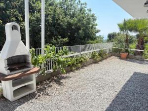 a garden with a grill next to a fence at Studio avec piscine et grande terrasse Parking gratuit Nice in Nice