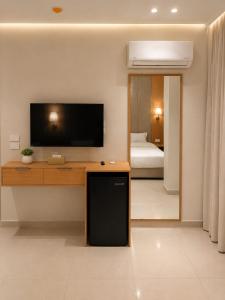 a living room with a flat screen tv on a wall at Up Town Crown Hotel in Cairo