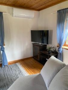 a living room with a couch and a flat screen tv at Bagarstugan in Älvdalen