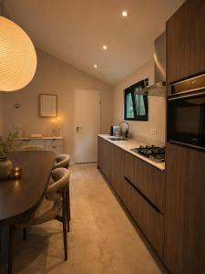 a kitchen with a table and a counter top at Huisje Mae in Nunspeet +14 photos