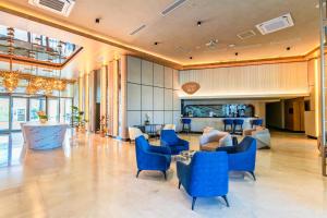 a large lobby with blue chairs and a table at Çenger Blue Collection Hotel Ultra All Inclusive in Manavgat +77 photos