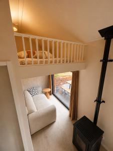 a living room with a bunk bed and a couch at Huisje Mae in Nunspeet