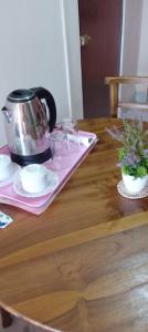 a table with a tea pot on top of it at The Golden Bow in Seeduwa +64 photos