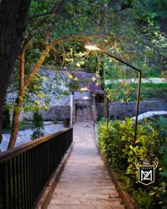 a walkway with a light on top of it at Resort Maja e Zezë in Gnjilane