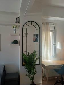 a room with a desk and a window and a mirror at Maria's Studio No3 in Heraklion in Thérissos