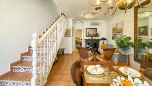 a dining room with a table and a staircase at NEW Villa Cabo Roig Coco-Mat 2 in Playas de Orihuela