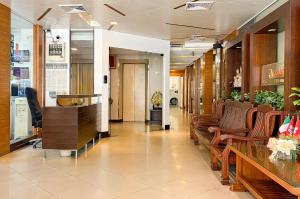 a lobby with chairs and tables in a store at K.V.Mansion in Bangkok