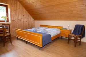 a bedroom with a bed and a table and chairs at Alpine Lodge Goška Ravan in Radovljica