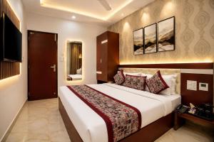 a hotel room with a large bed and a television at Hotel Tamanna 2 Minute Walk from Golden Temple in Amritsar