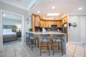 a kitchen with a island with bar stools at Phoenix on the Bay 1328 in Orange Beach