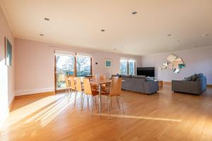 a living room with a table and chairs and a couch at Homeview - Elie & Earlsferry in Elie