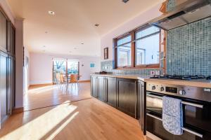 a kitchen with a sink and a stove at Homeview - Elie & Earlsferry in Elie