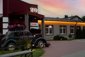 an old car parked in front of a store at HOUSE silver in Ivano-Frankivsk