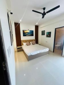 a bedroom with a bed and a ceiling fan at Phool Ghar by Hrittika in Siroli