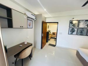 a living room with a desk and a hallway at Phool Ghar by Hrittika in Siroli