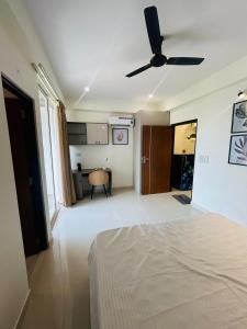 a bedroom with a bed and a ceiling fan at Phool Ghar by Hrittika in Siroli