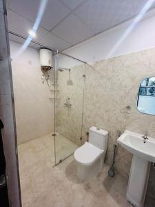 a bathroom with a shower and a toilet and a sink at Phool Ghar by Hrittika in Siroli
