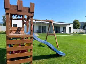 a playground with a slide in a yard at ELEM apartments in Liptovský Mikuláš
