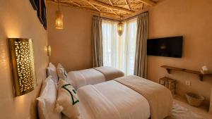 a hotel room with two beds and a window at Palm Surf & Spa Hotel in Agadir