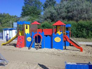 a playground with a slide in the sand at Hotel Playa Blanca in Duna Verde