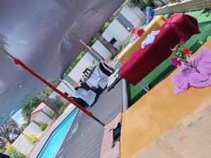 a red umbrella on top of a building with a pool at Moonlight Guesthouse in Bloemfontein +2 photos