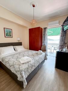 a bedroom with a large bed and a window at Avli Studios in Nydri
