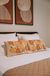 a bed with two pillows on top of it at Tina's Resident in Igoumenitsa