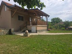 a house with a porch and a balcony at Seosko domaćinstvo Trajković in Mladenovac +14 photos