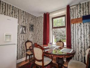 a dining room with a table and a window at Keepers Cottage in Peterhead