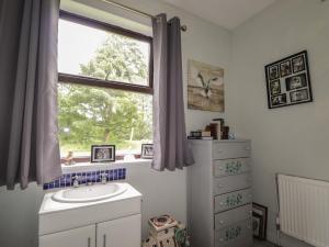 a bathroom with a sink and a window at Keepers Cottage in Peterhead +13 photos